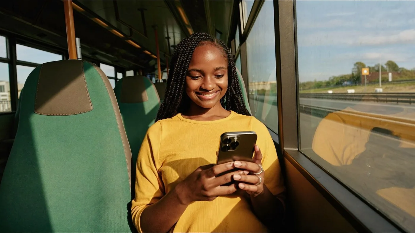 A woman on a train using the Sao app on her phone